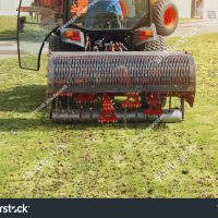 stock-photo-gardener-operating-soil-aeration-machine-on-grass-lawn-647739316